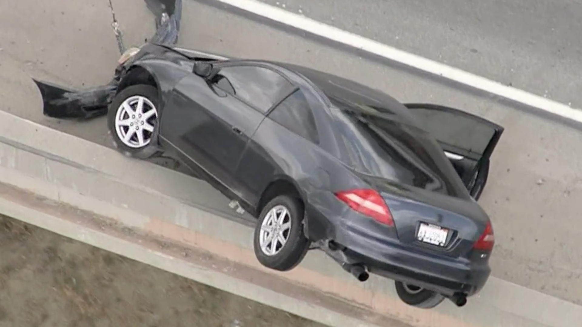 Watch a Crashed Honda Accord Coupe Dangle Off an Overpass