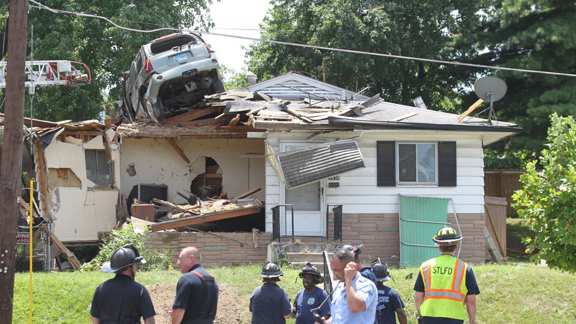 SUV Crashes on Roof of House in St. Louis