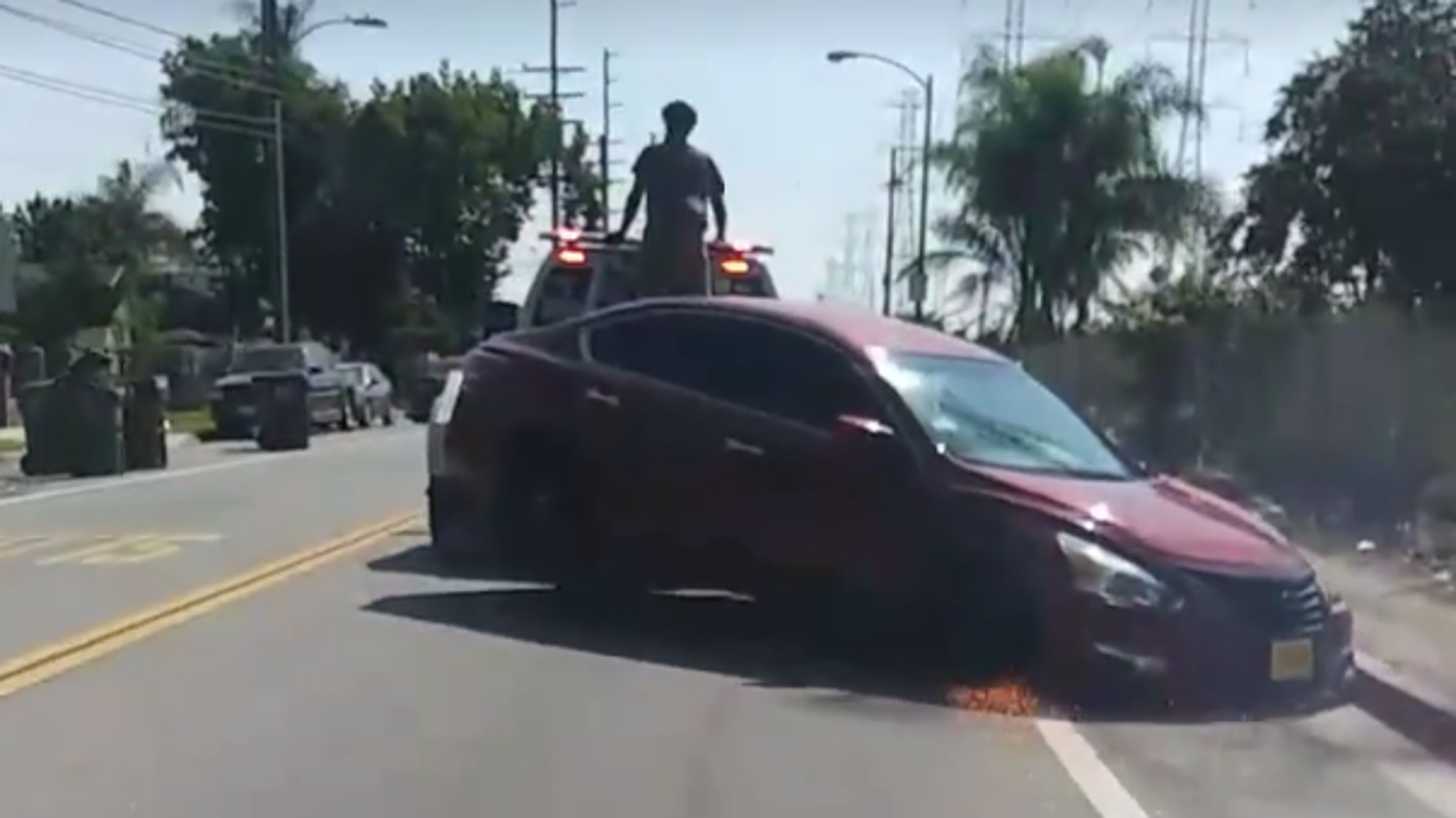 Wild Video Shows Tow Truck Dragging Repo’d Nissan Altima While Owner Tries to Free It