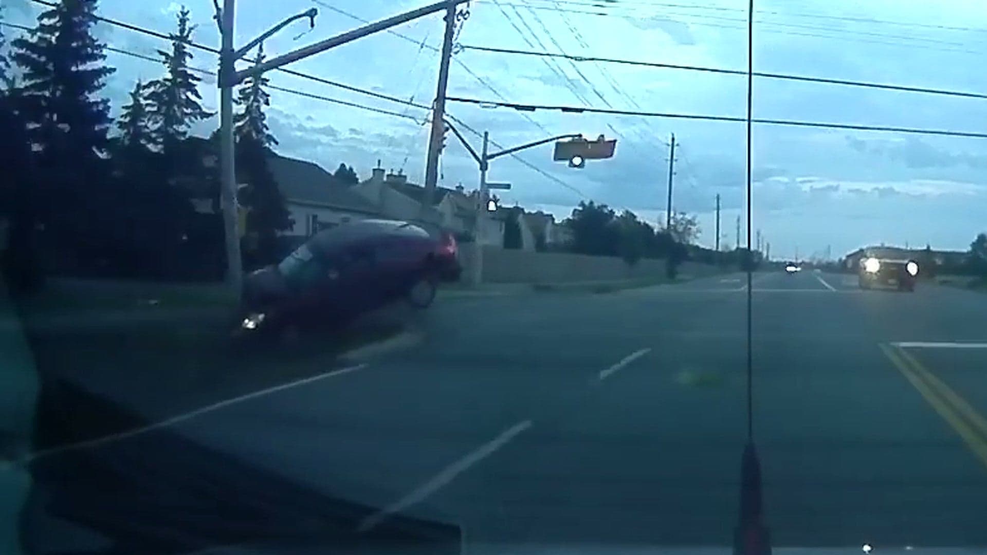 Watch This Inattentive Driver Soar Over an Intersection and Smash Into a Pole