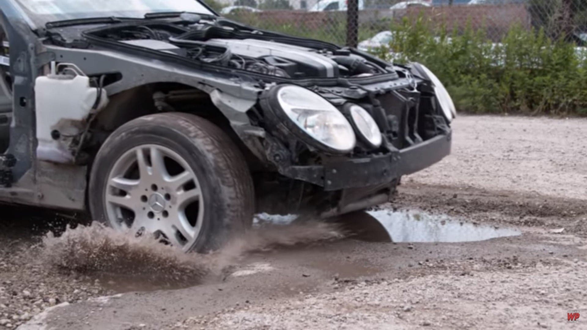 Watch a Stripped Mercedes E-Class Get Smashed up Over Bad Potholes on Purpose