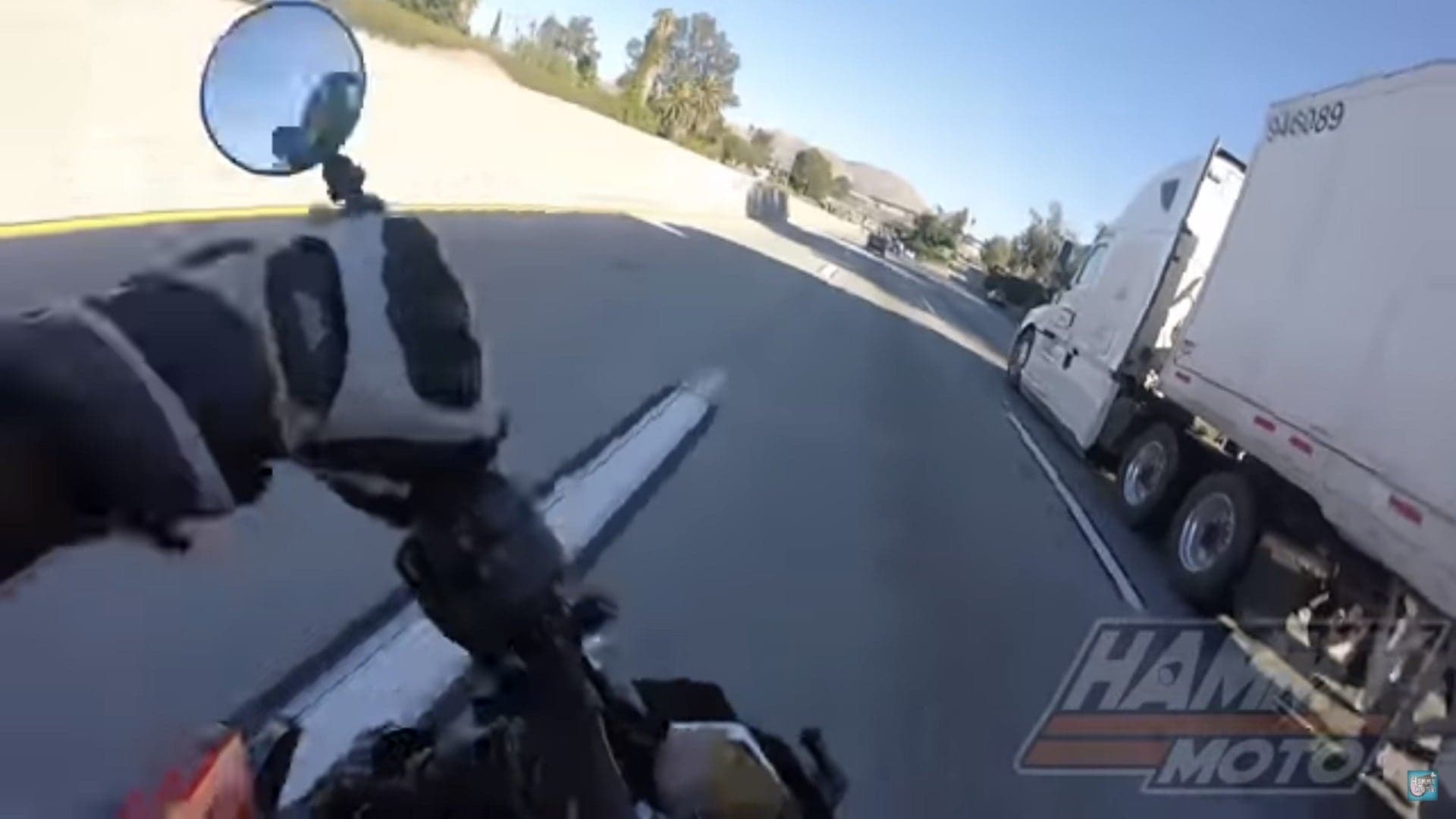 Watch This Biker Narrowly Avoid Becoming a Human Pancake Under a Truck