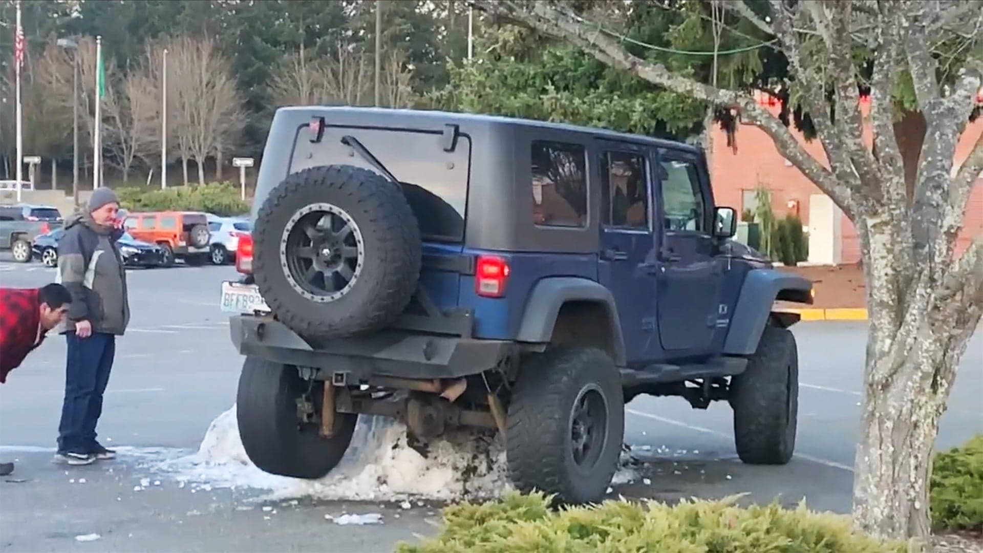 Watch a Lifted Jeep Wrangler Get Stuck on a Tiny Snow Pile in a Parking Lot