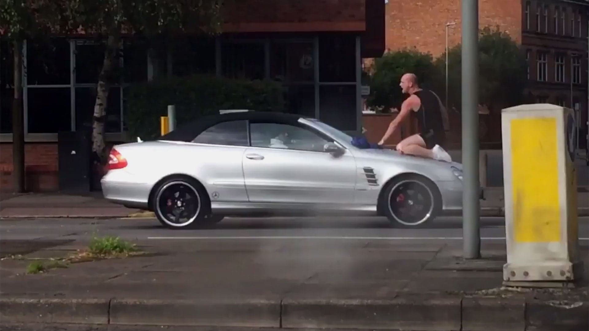 Watch This Crazy Man Headbutt a Moving Mercedes CLK