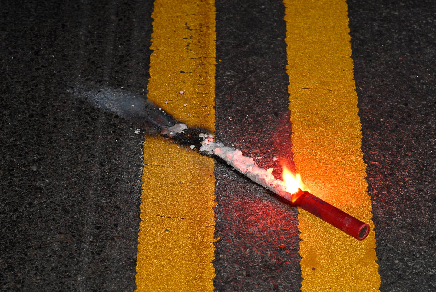 Close up road flare on pavement