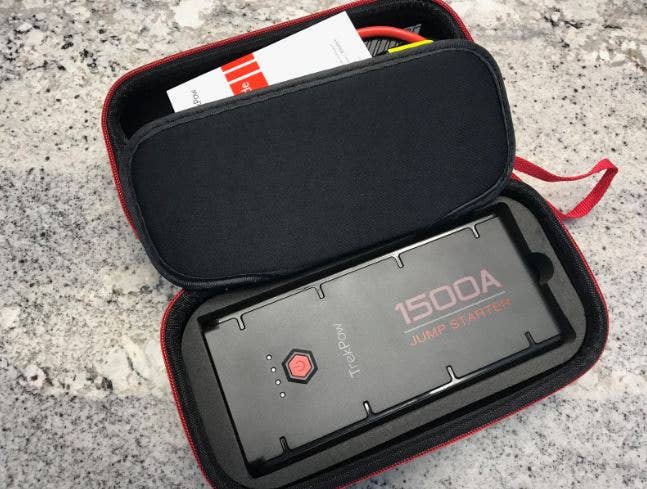 A jump starter and accessories in a soft case.