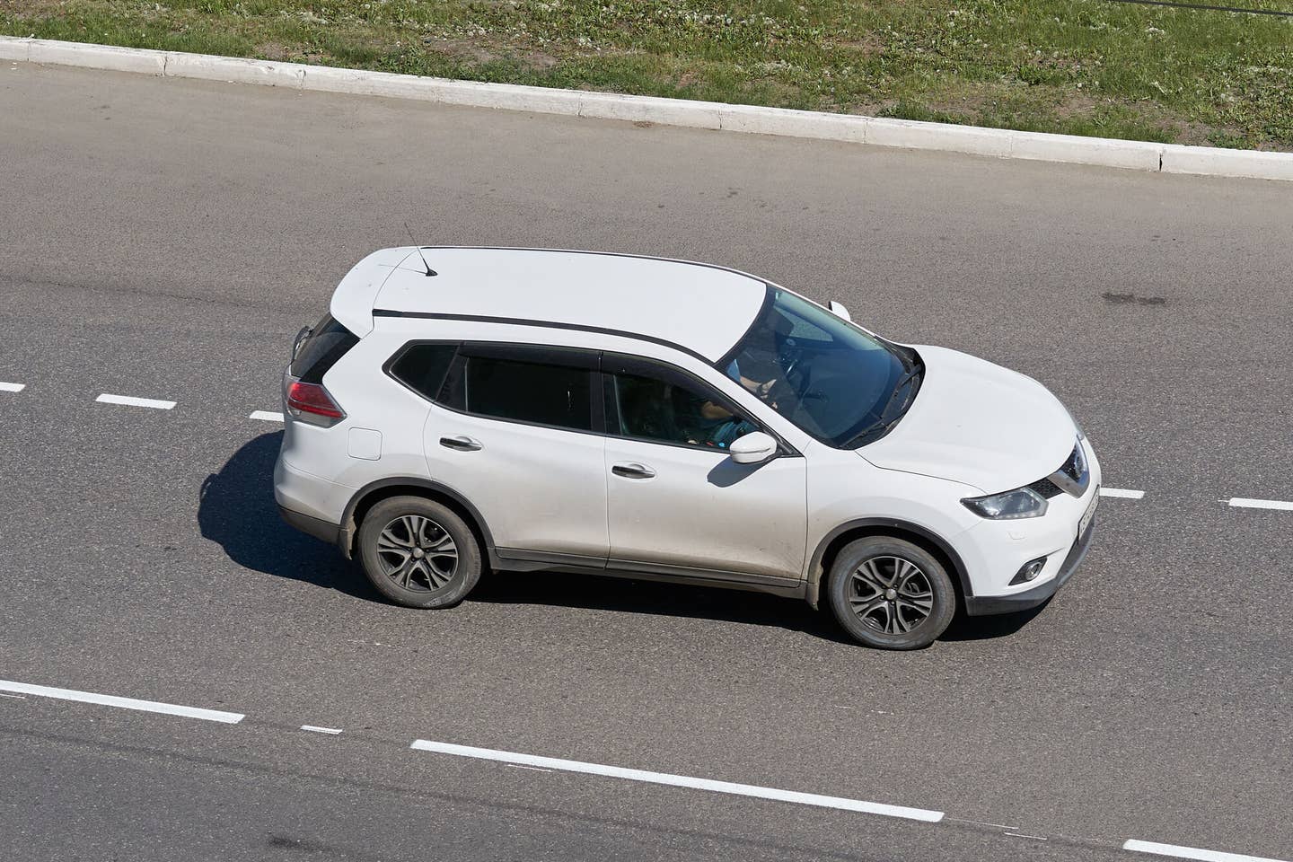 White Nissan Rogue on the street