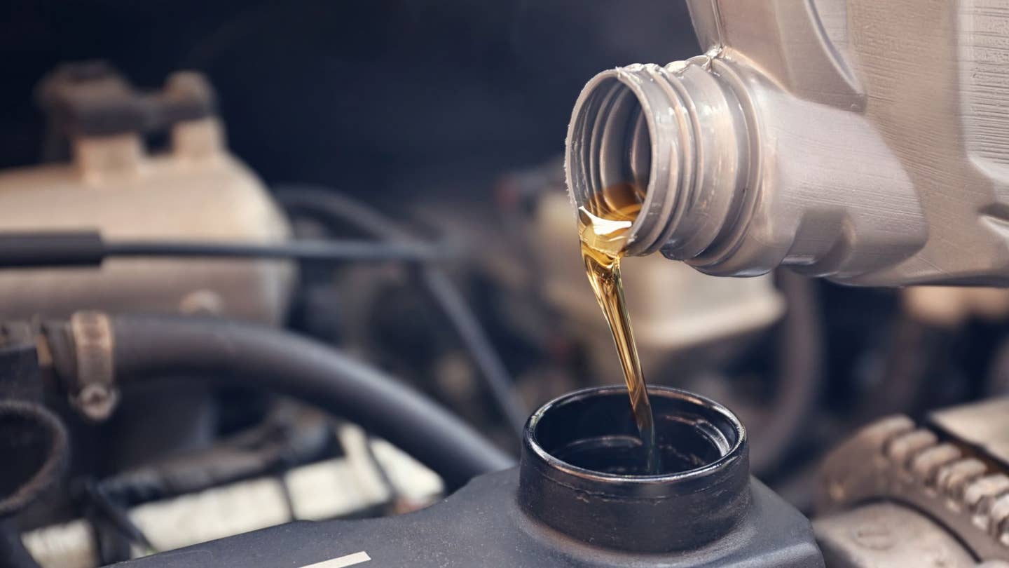 New synthetic oil is poured into the engine.