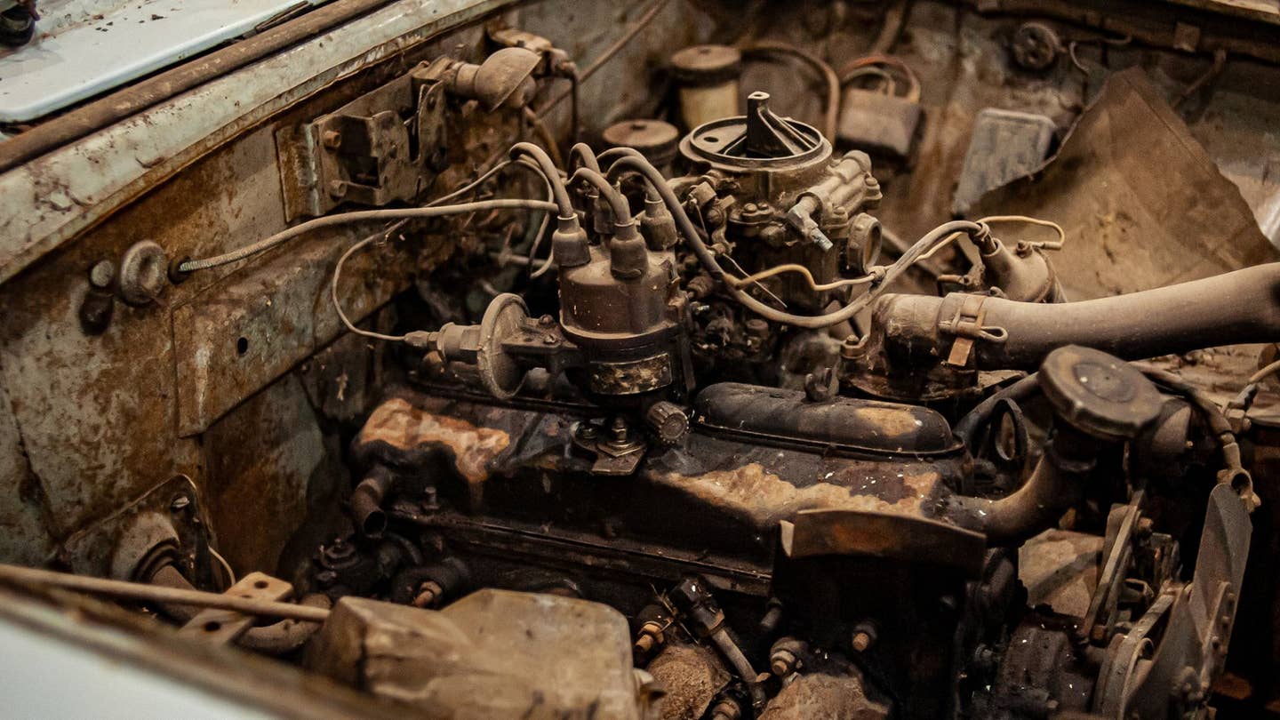 A very dirty, rusting engine.