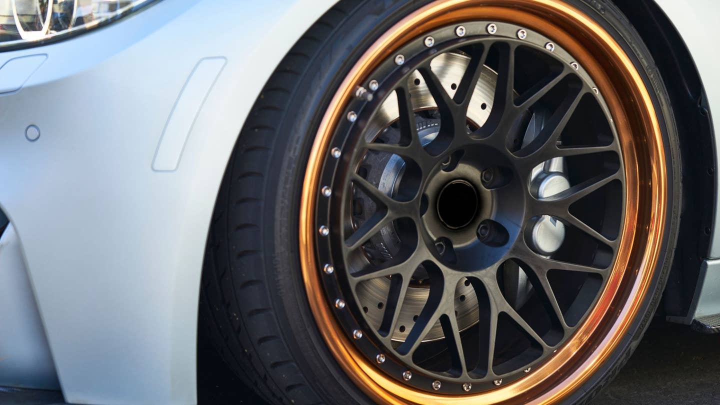 BMW brakes seen through its aftermarket wheel.
