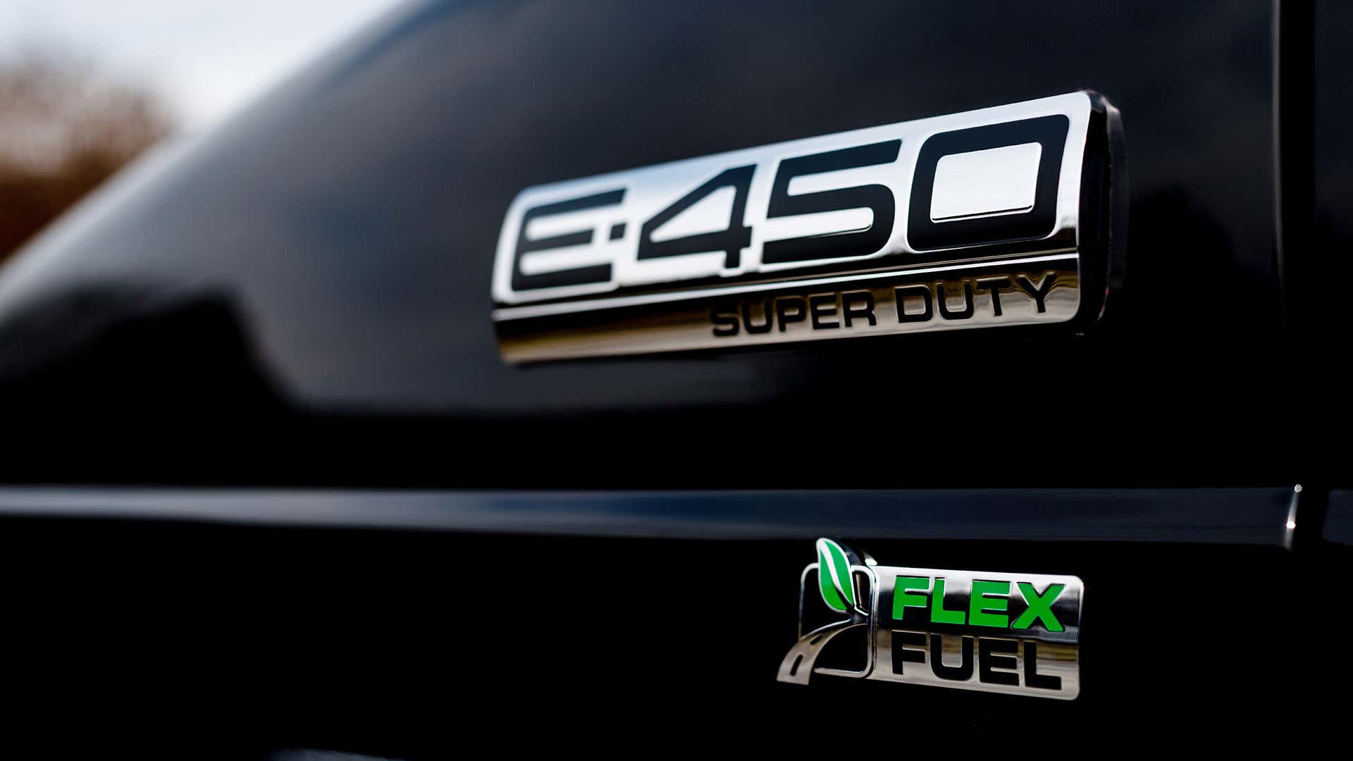 A Ford E-450 Super Duty Flex Fuel badge.