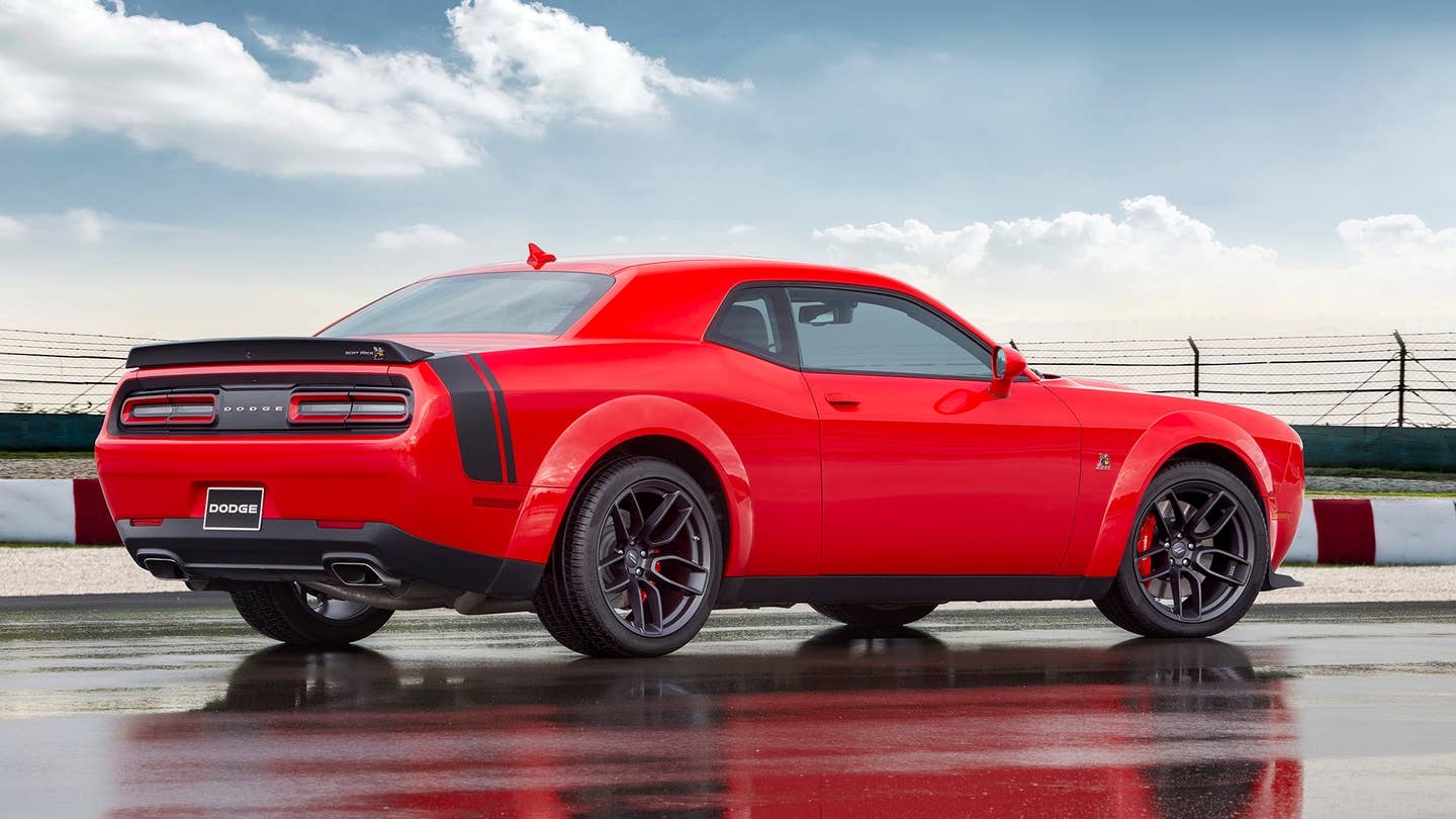 The rear end of a red 2021 Dodge Challenger Scat Pack with.