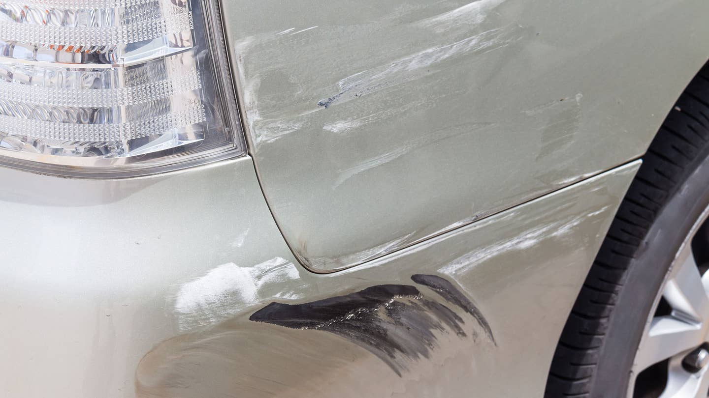 Dark paint transfer soils an off-white car.