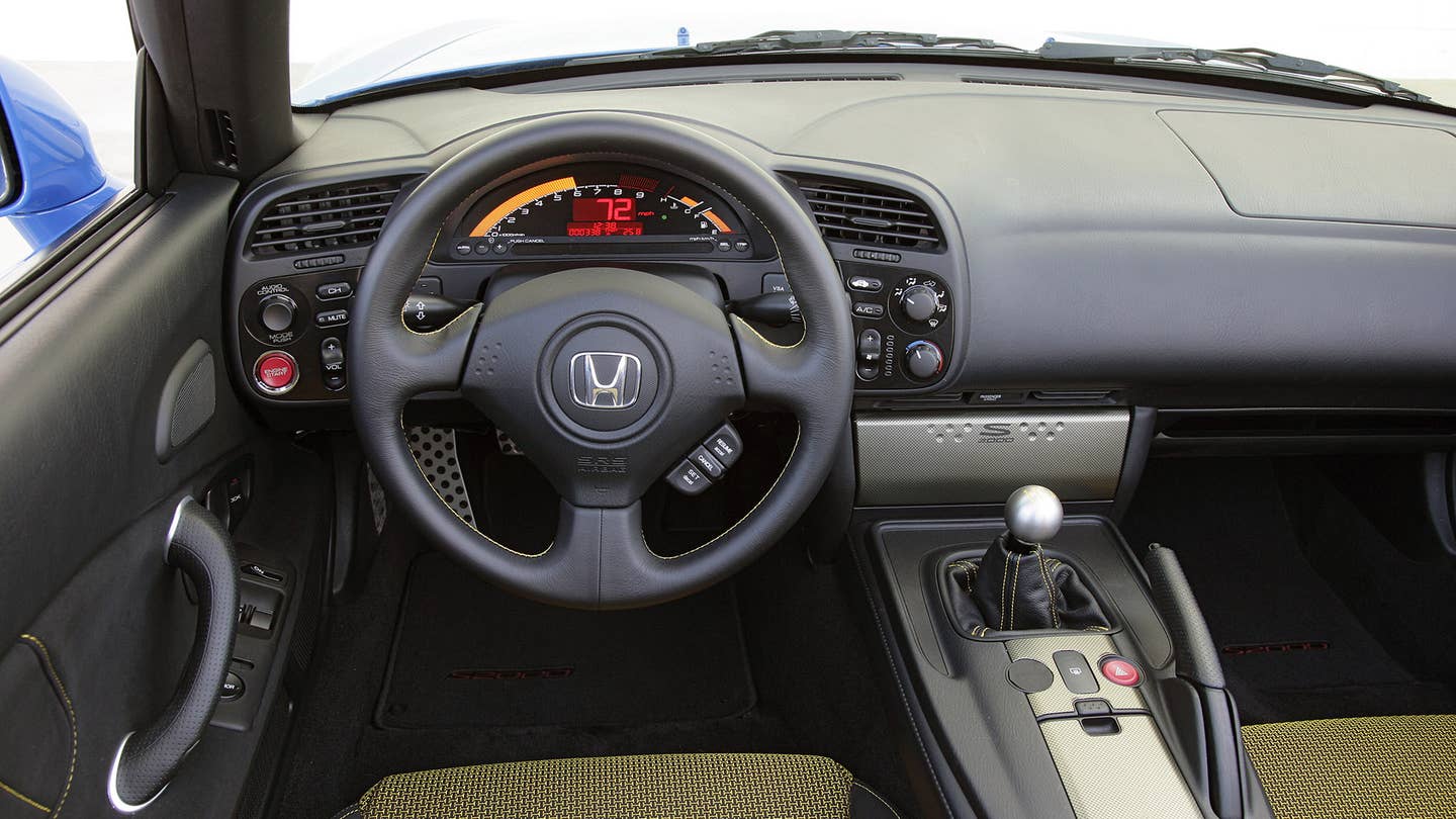 The black interior of the Honda S2000 CR Prototype features a manual transmission.