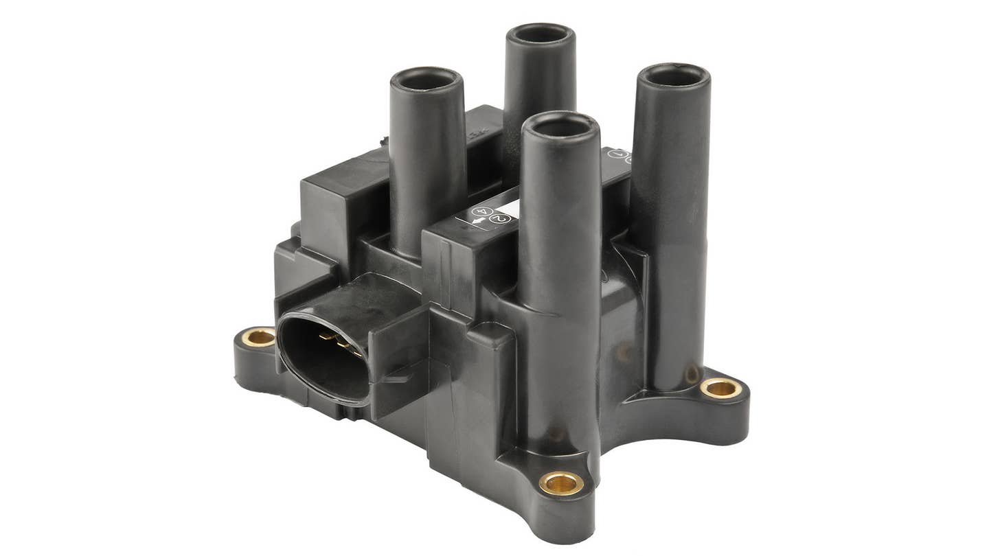 A black ignition coil pack on a white image.