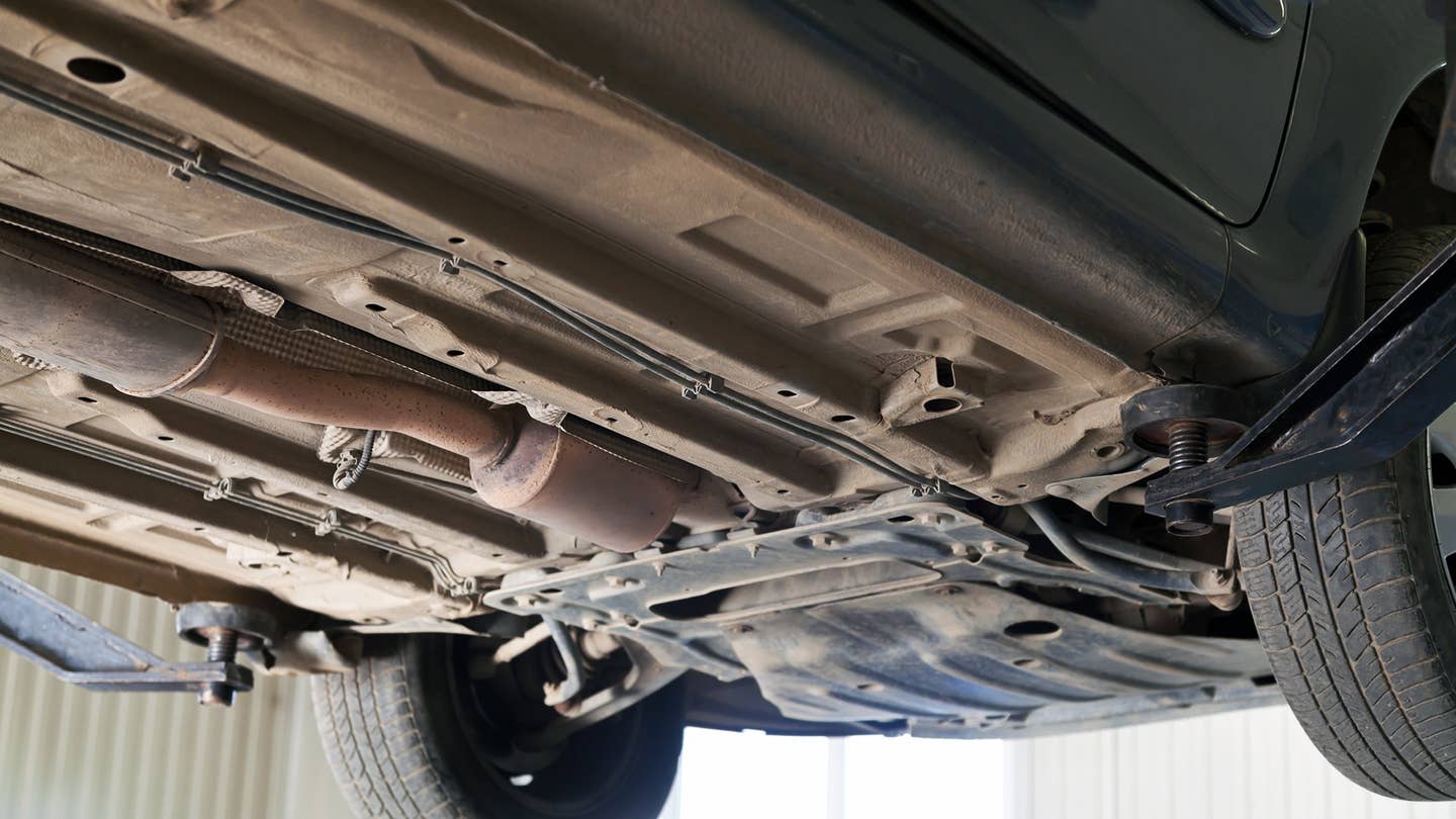 The exhaust system is tightly tucked underneath a car.
