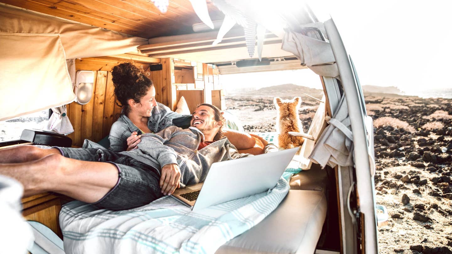 A couple lounging in their van. 