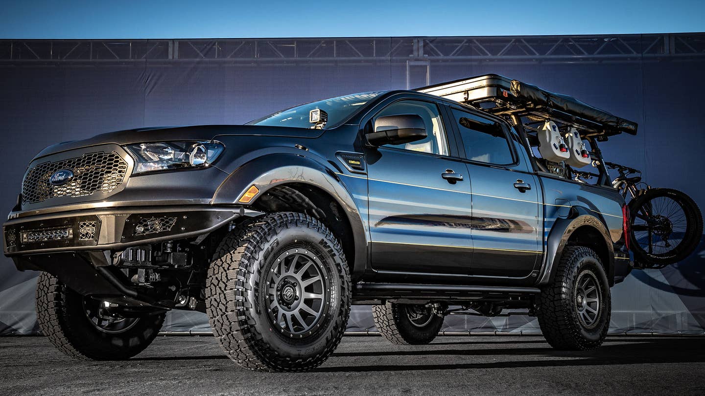 An adventure-customized Ford Ranger with chunky tires and a bike rack.