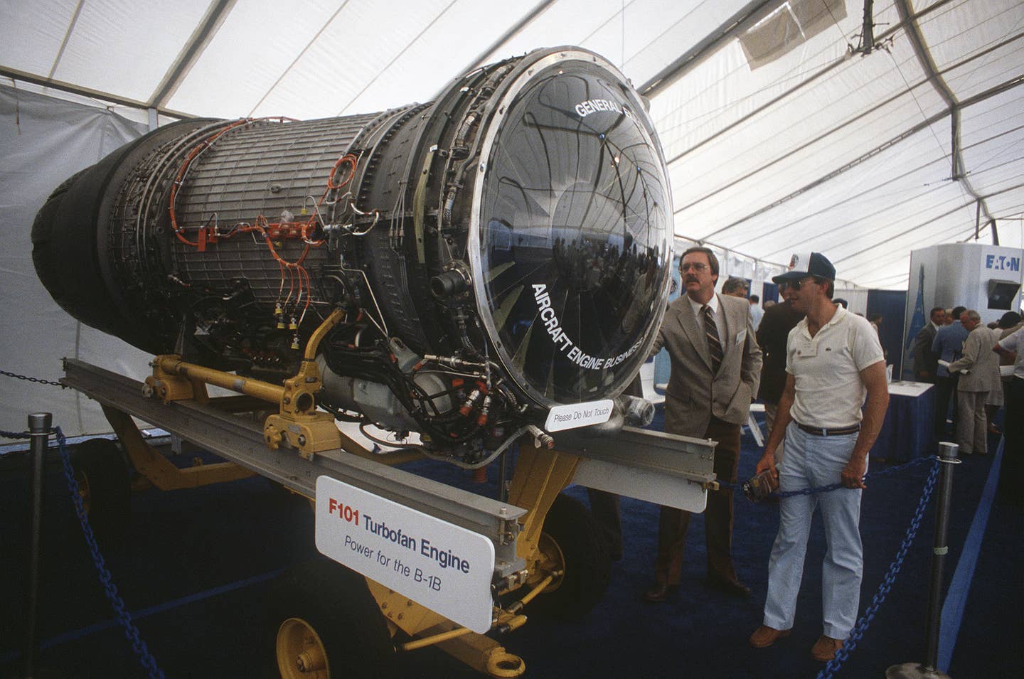 message-editor%2F1610130215632-visitors_attending_the_rollout_ceremony_for_the_first_production_model_b-1b_aircraft_examine_a_model_of_a_f101_turbofan_jet_engine_at_the_rockwell_international_facility._four_f-101_engines_power_the_b-1b.jpg