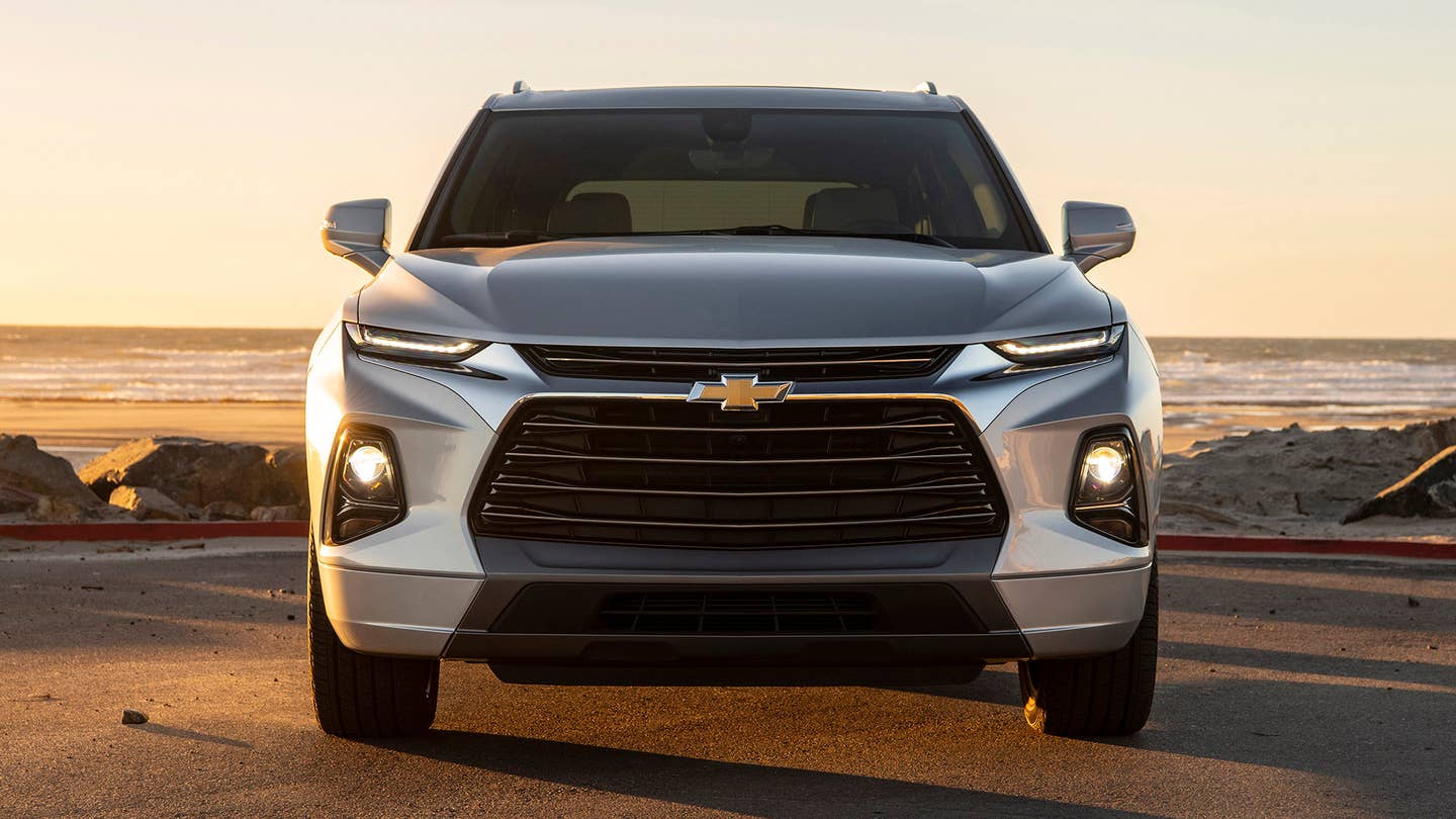 A silver 2019 Chevrolet Blazer shows its HID headlights at the beach.