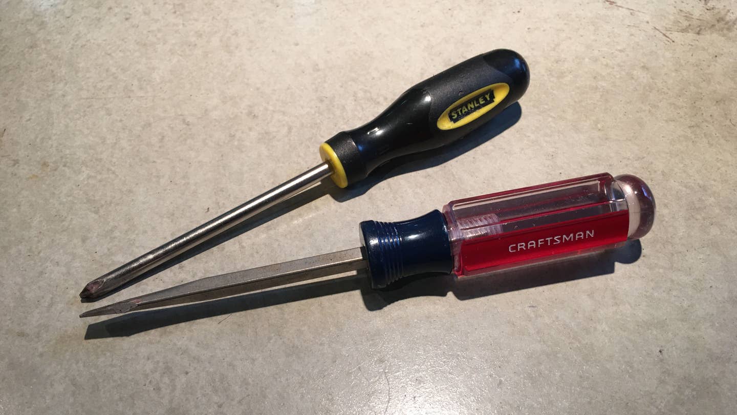 Craftsman and Stanley screwdrivers on a concrete background.