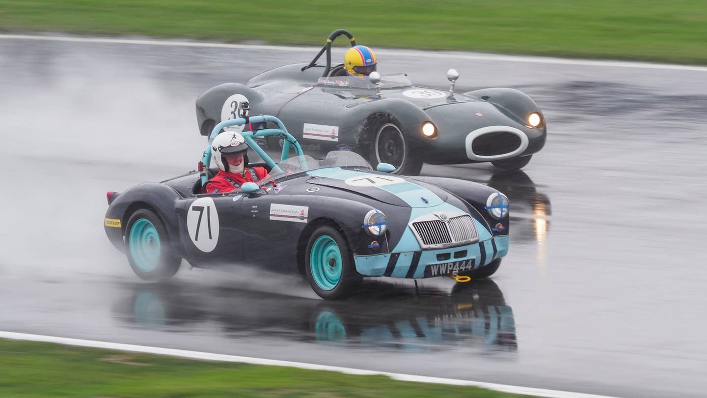 Classic racecars driving in the wet.