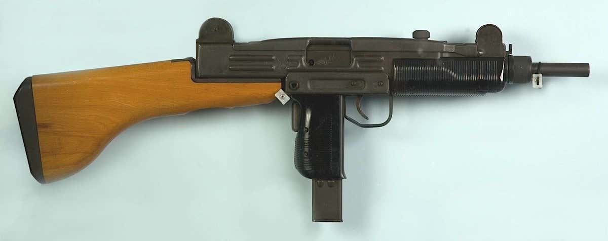 A standard Uzi submachine gun with a fixed wooden stock. 