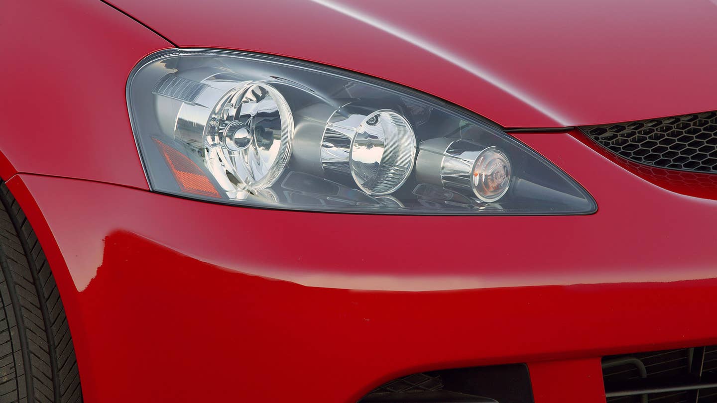 The headlight of the 2005-2006 Acura RSX Type S in red.