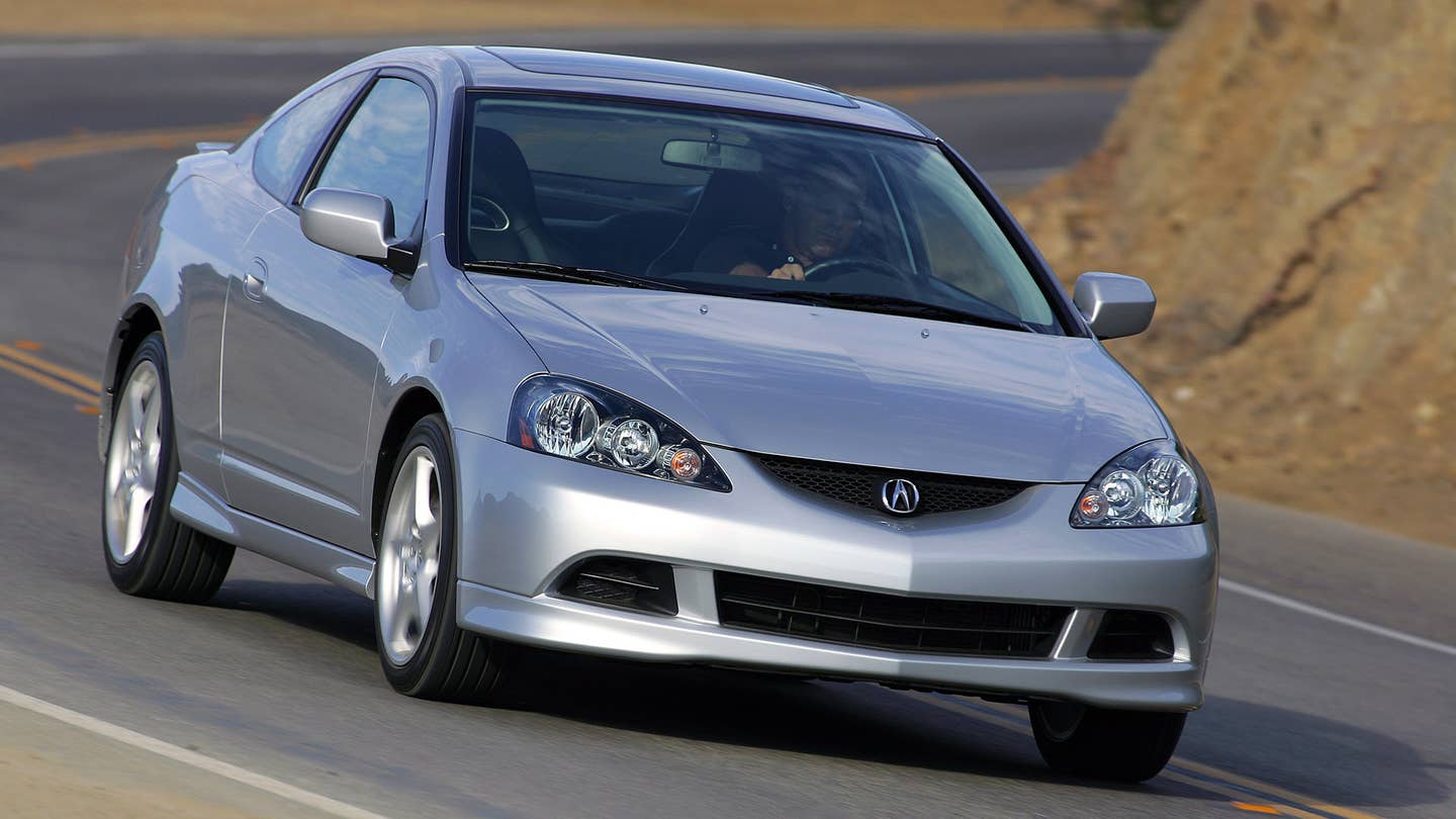 A rolling shot of a 2005-2006 Acura RSX Type S in silver.