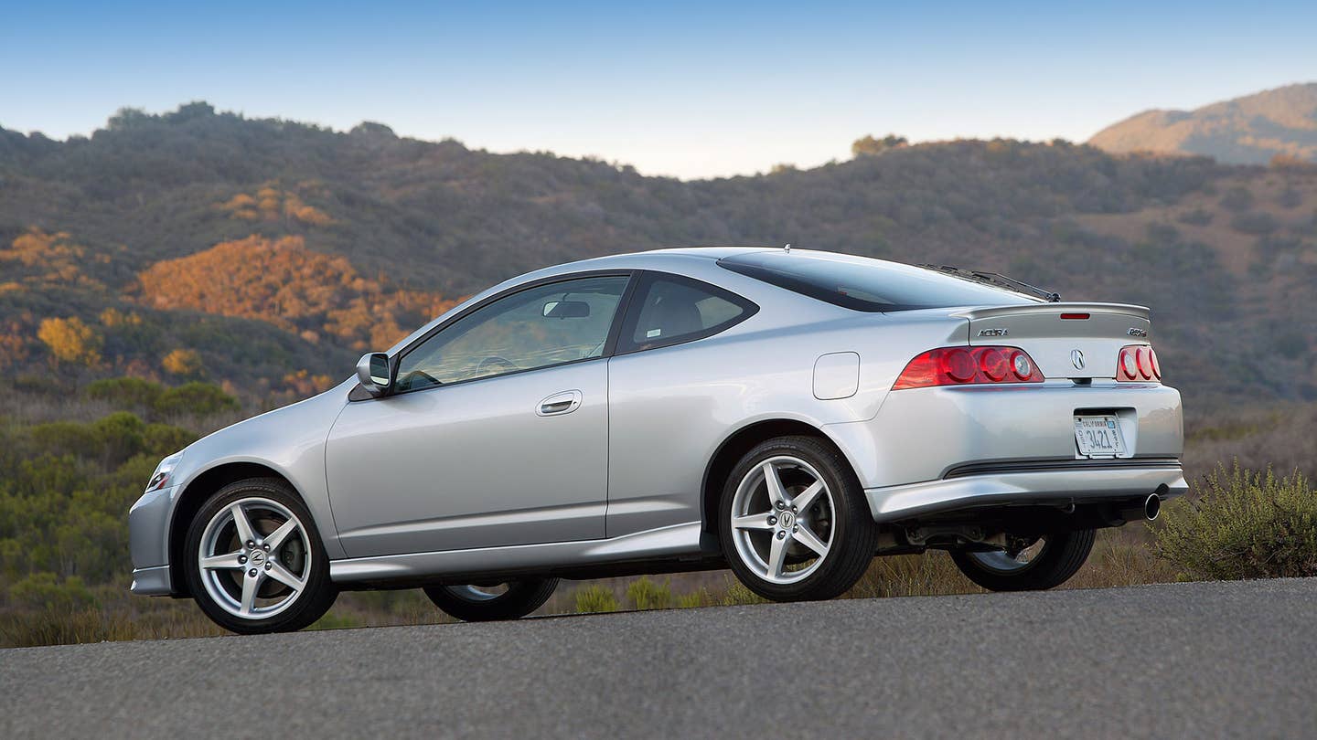 The rear quarter view of the 2005-2006 Acura RSX Type S in silver.