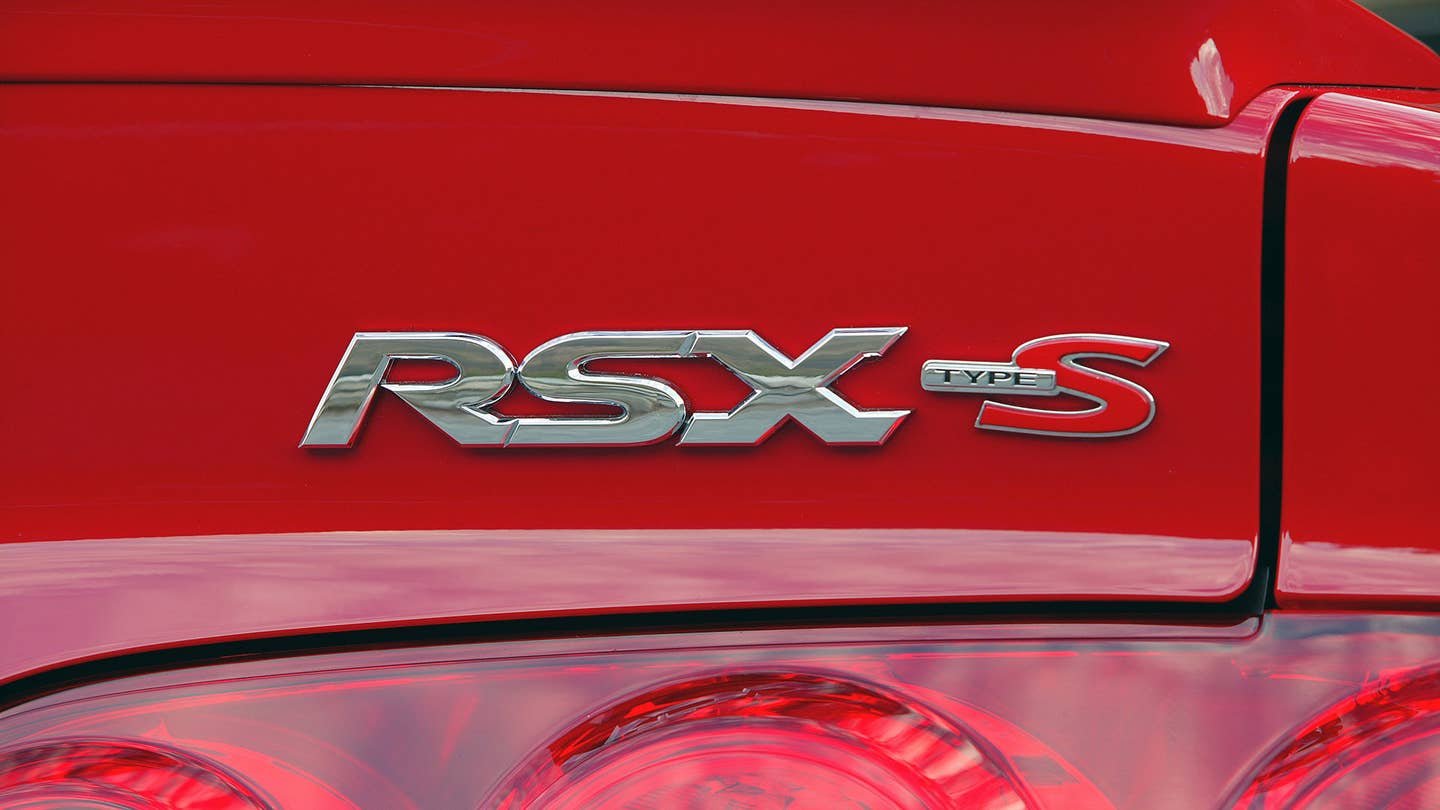 The rear badging on a red 2005-2006 Acura RSX Type S.