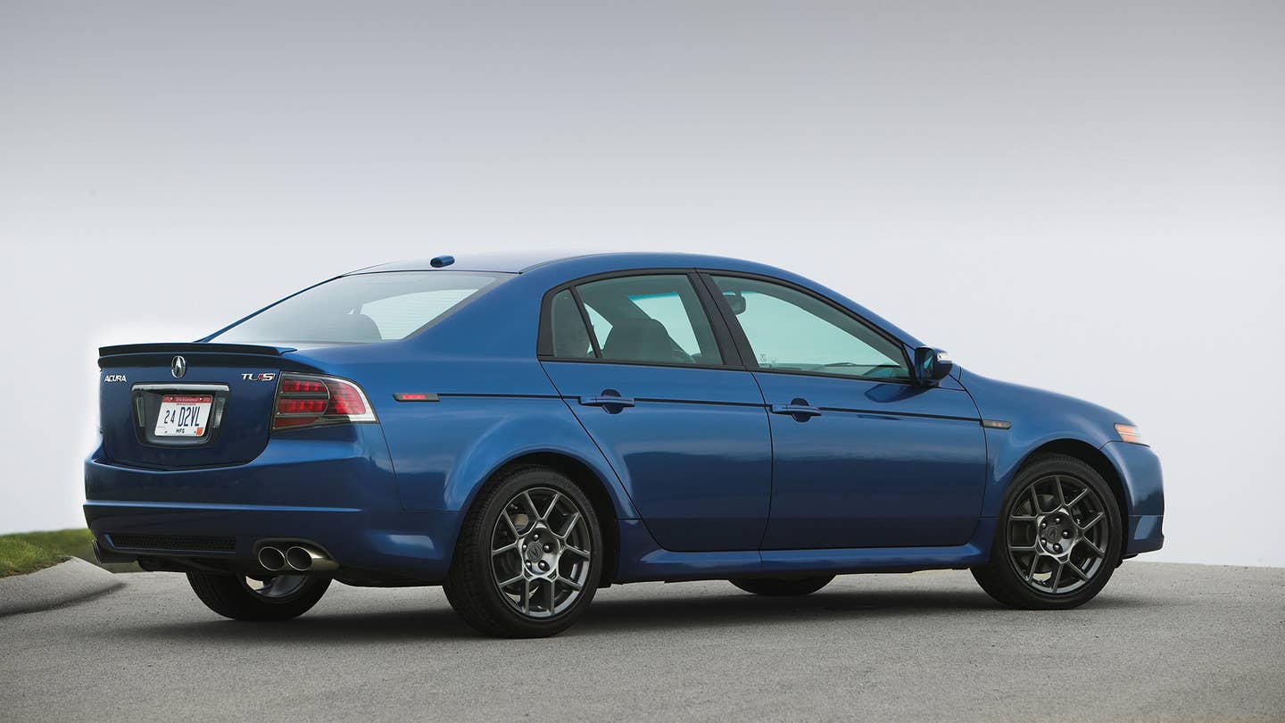 The rear quarter angle of a blue 2007-2008 Acura TL Type S.