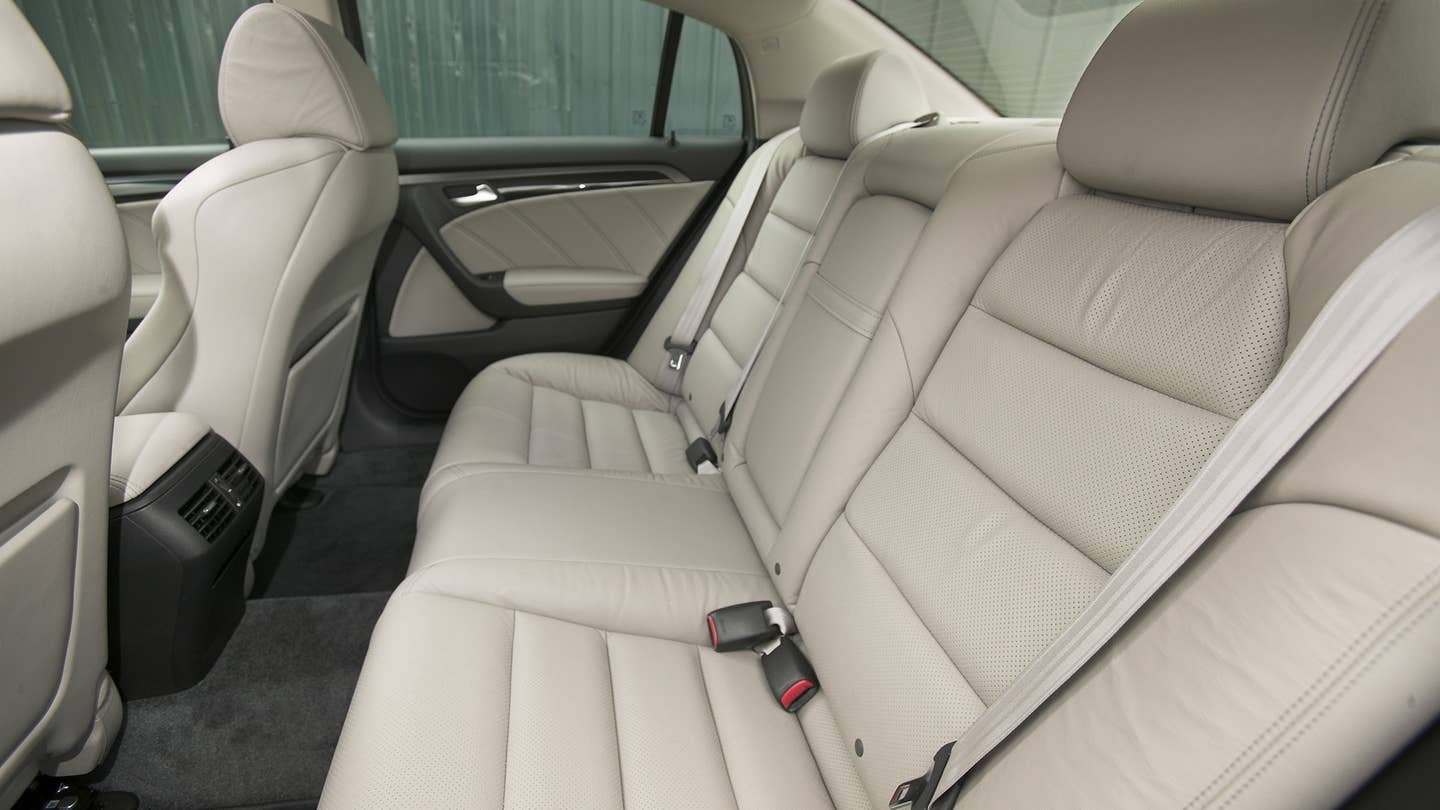 The beige leather seats in the back of a 2007-2008 Acura TL Type S.