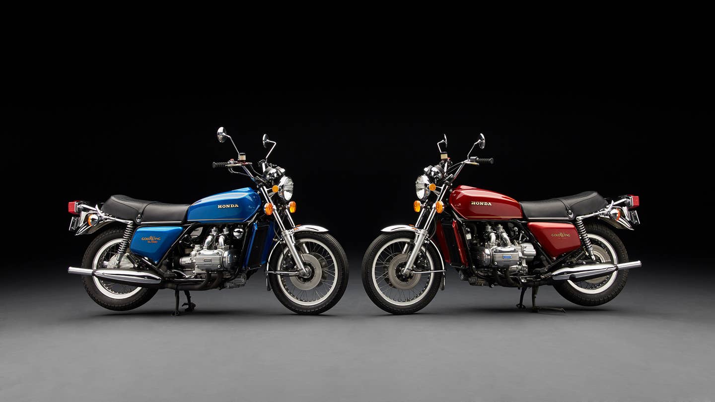 Blue and red vintage Honda Goldwings pose in a studio.
