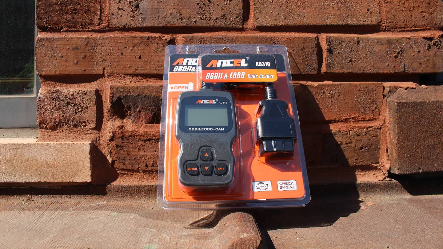 The Ancel AD310 OBD reader in the plastic packaging.