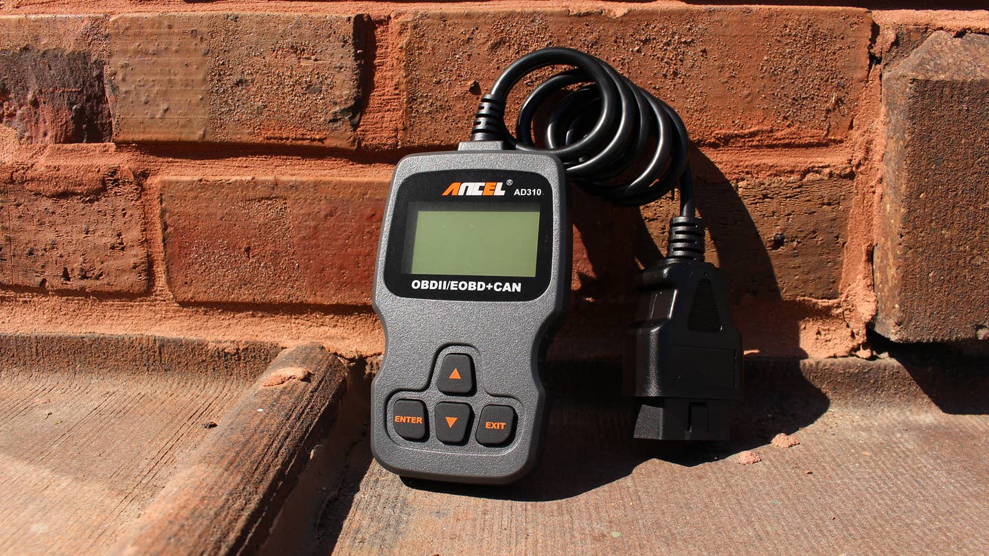 The Ancel AD310 OBD reader outside of its plastic packaging.