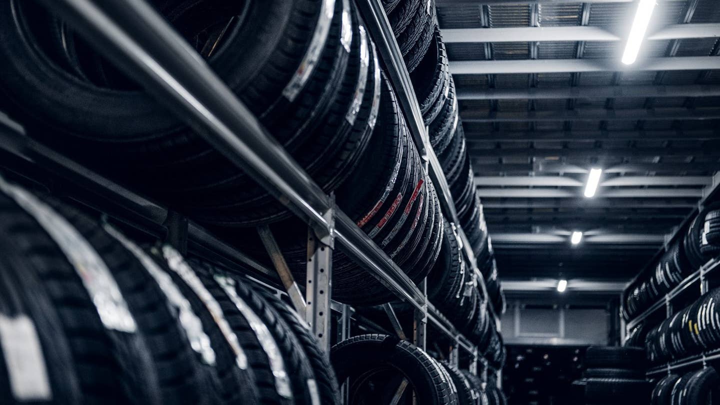 Multiple racks of tires in a tire warehouse.