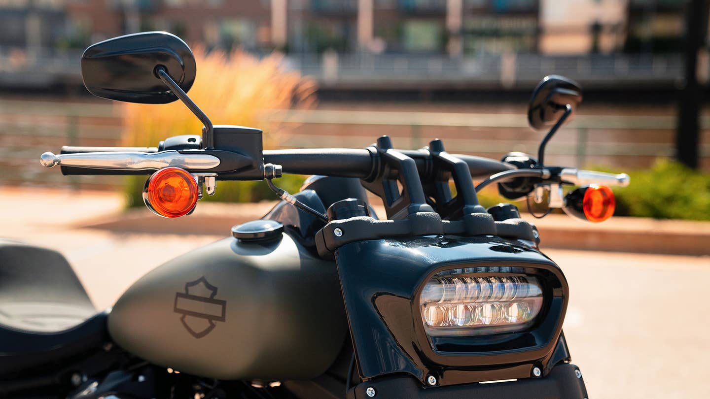 A Harley-Davdison Fat Bob 114's horizontal oval headlight and handlebars.