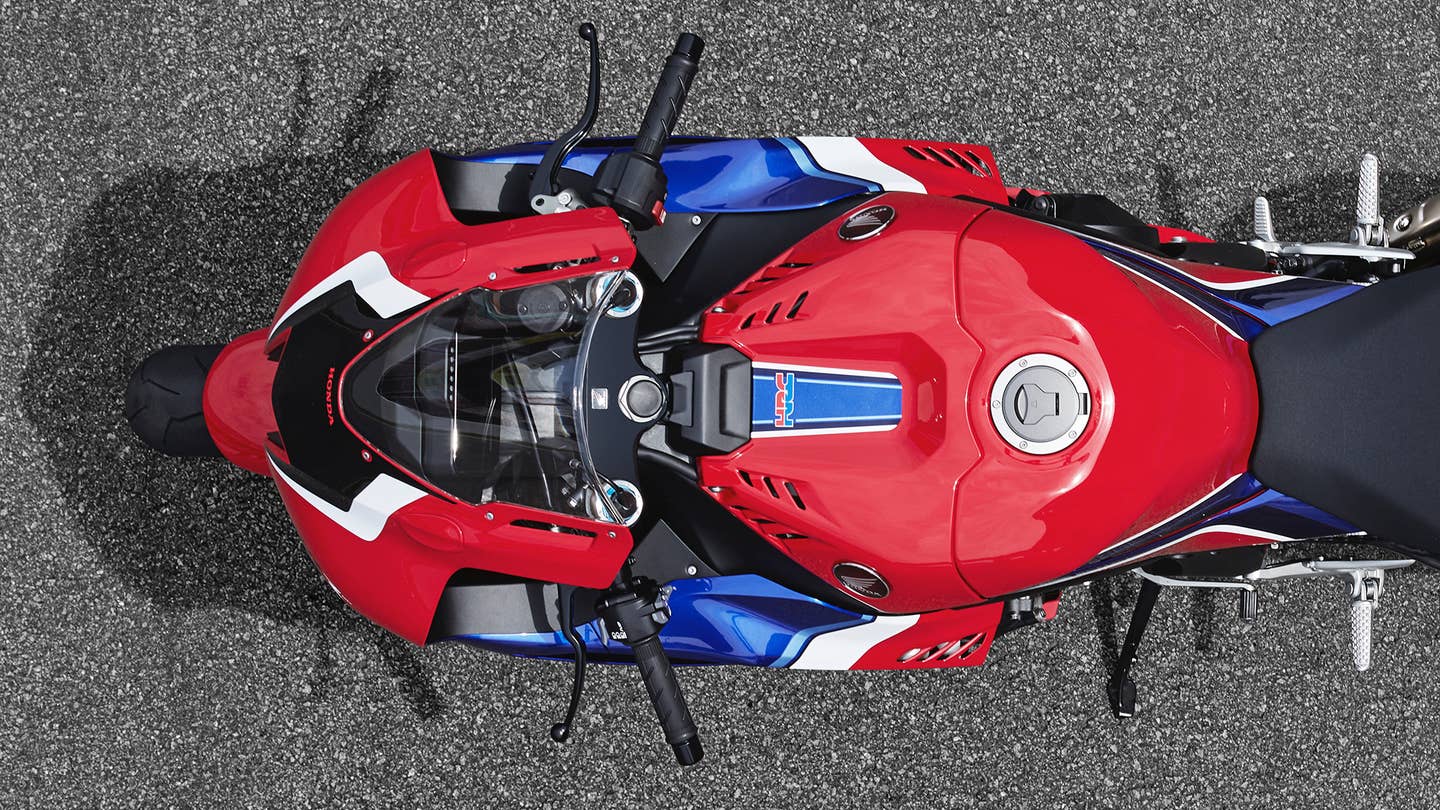 An overhead view of the front end of a red, white, and blue Honda CBR sport bike.