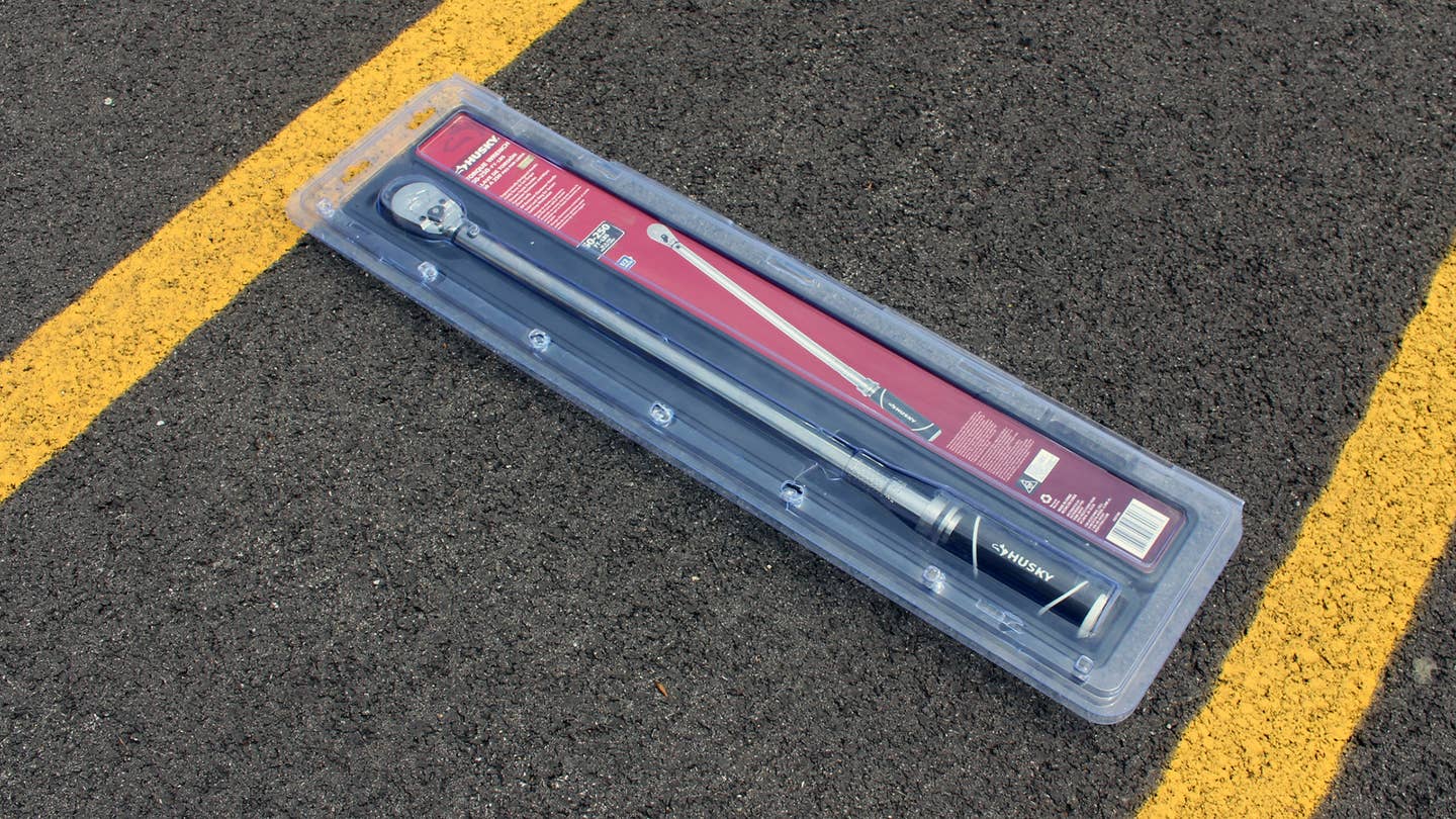 A Husky Torque Wrench with 1/2-inch Drive in its packaging on the ground. 
