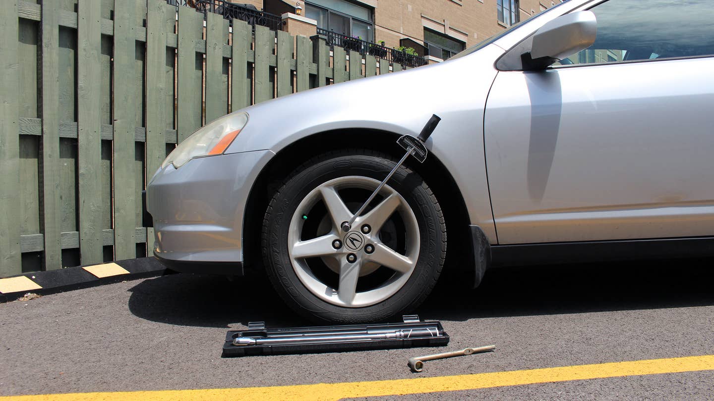 A Husky Torque Wrench with a 1/2-inch drive is used on a 2003 Acura RSX to tighten the lug nuts.