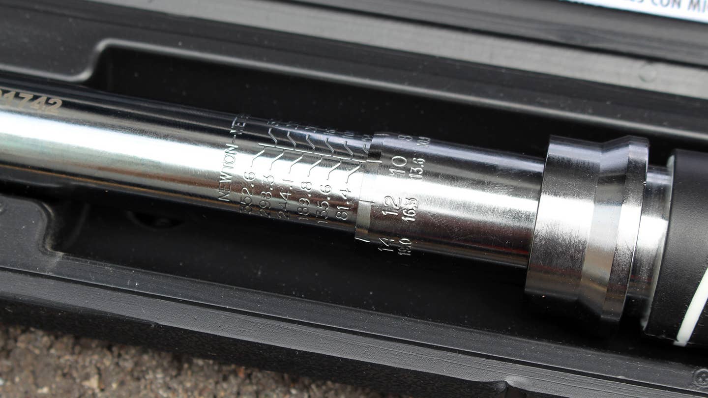 A Husky Torque Wrench with a 1/2-inch drive is used on a 2003 Acura RSX to tighten the lug nuts.