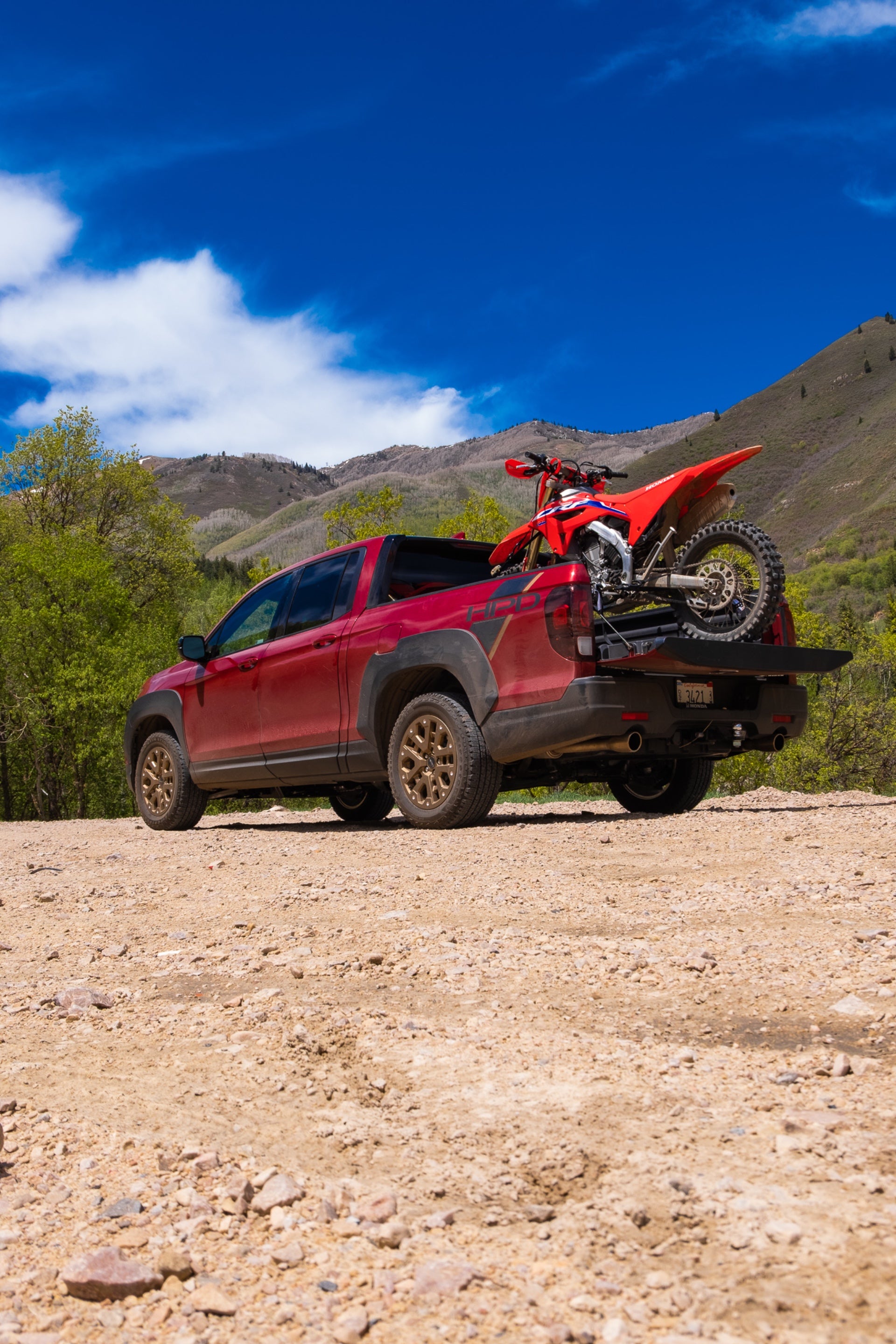 The Ridgeline with a CRF450RX in the bed.