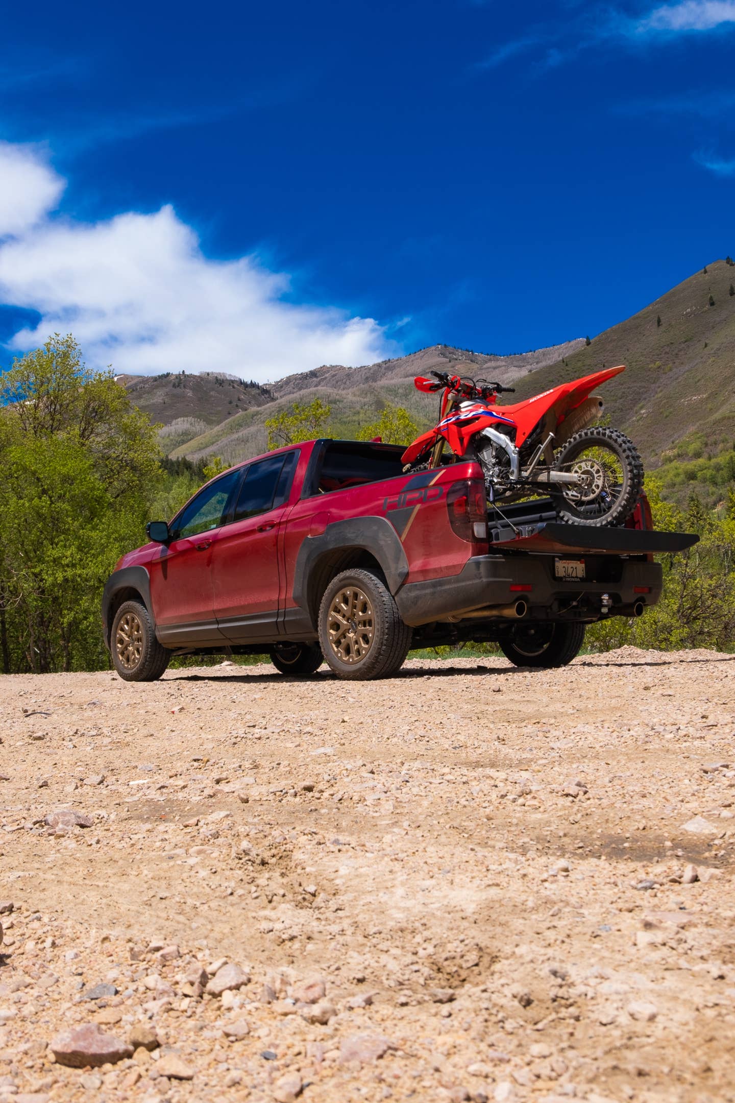 The Ridgeline with a CRF450RX in the bed.