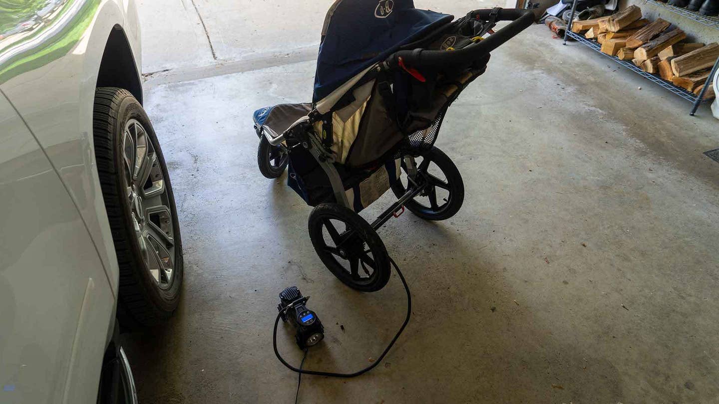 Blowing up the stroller's tires. 