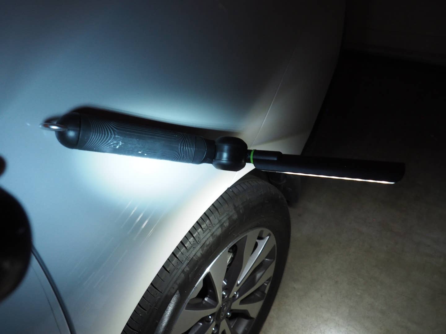 The MYCHANIC Blade light magnetized to the side of a car.