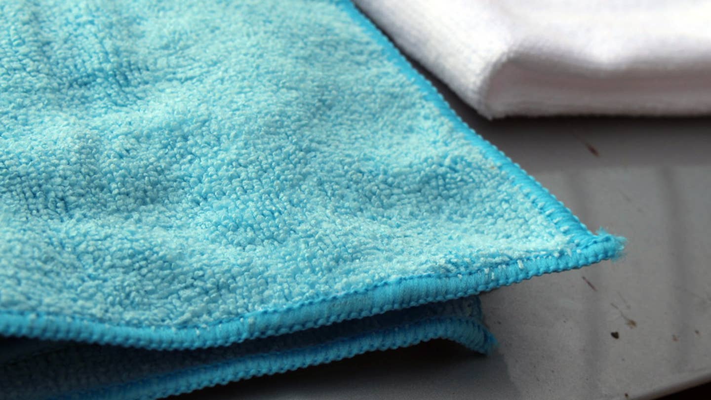 A close-up of the corner of a blue Amazon Basics microfiber towel.
