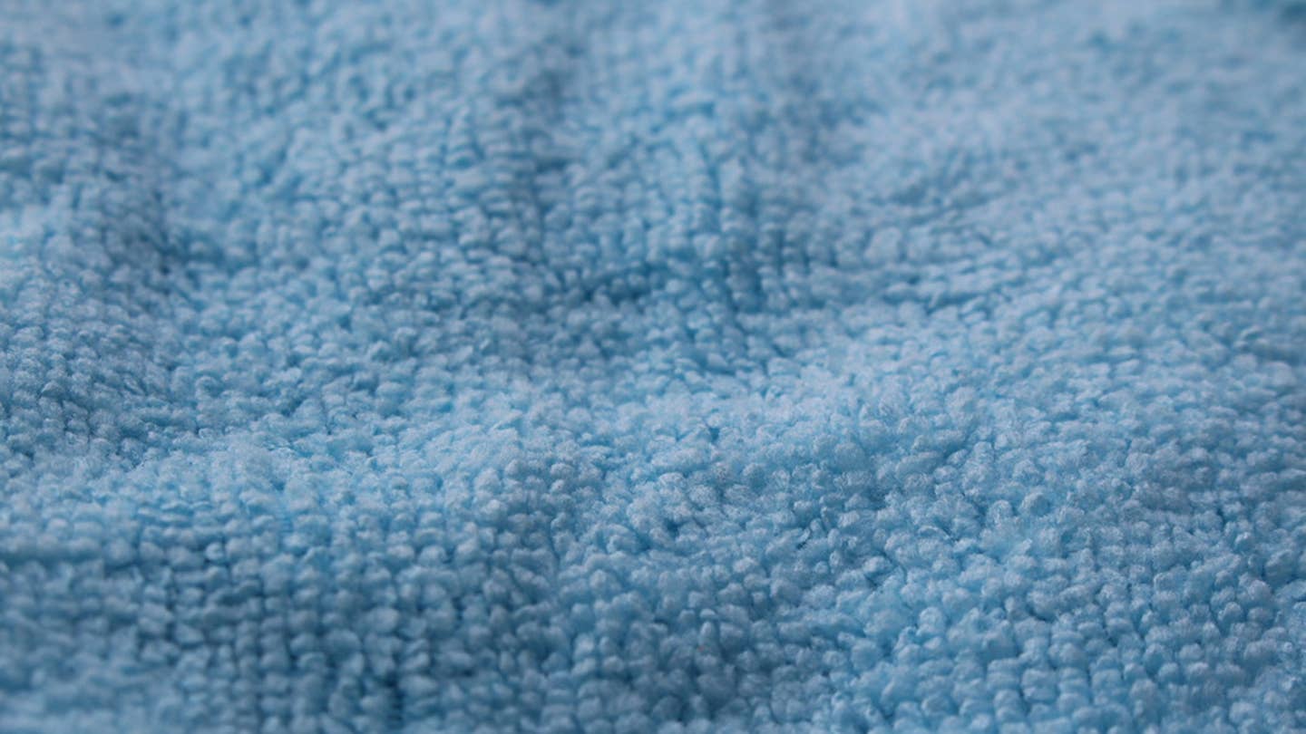 A close-up of a blue Amazon Basics microfiber towel's texture..