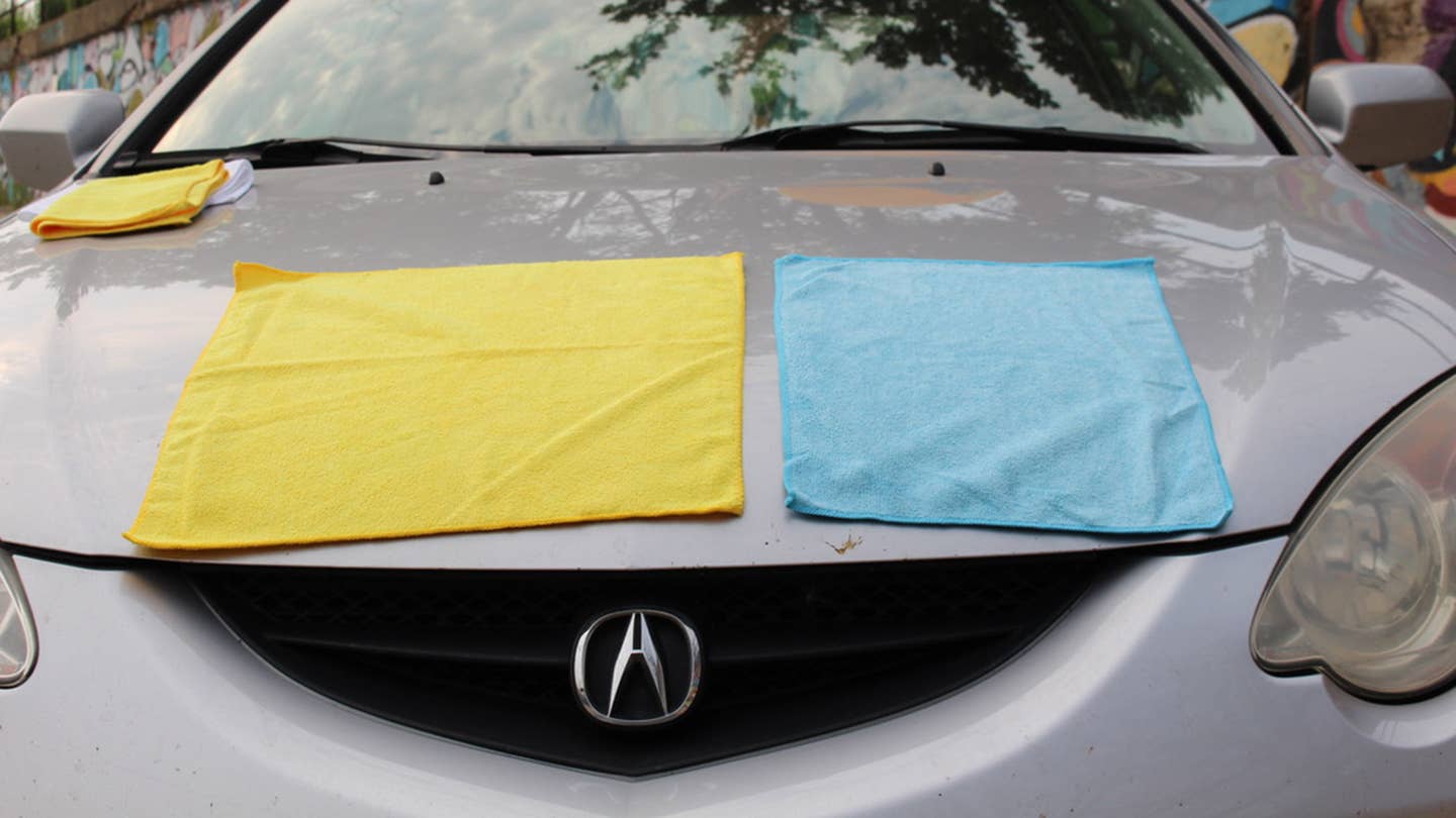 A comparison of size between Amazon's blue microfiber towel and Costco's bigger yellow microfiber towel.