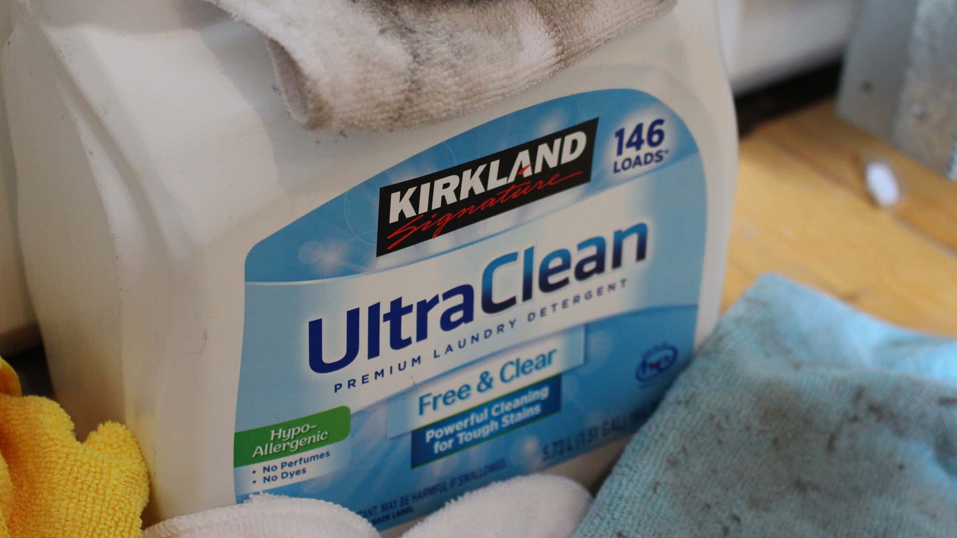 A close-up view of a large container of Kirkland Signature UltraClean Free and Clear detergent.